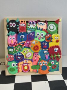 A colorful clay photo frame made of lightweight modeling clay with creative floral and different decorations.