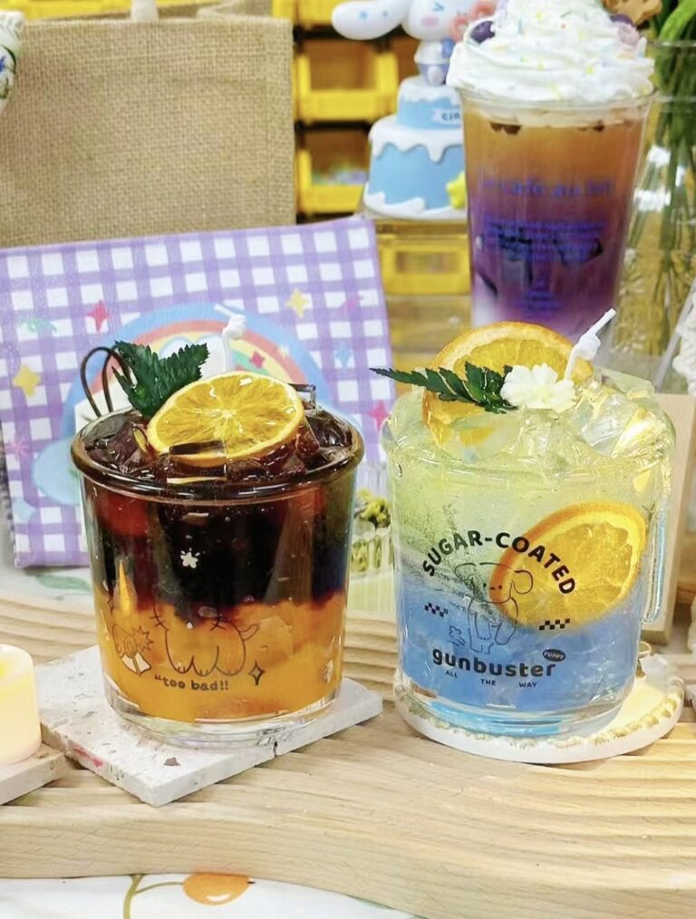 Colorful beverage-inspired Martini Candle DIY with orange slices and ice cube details in creative glass designs.