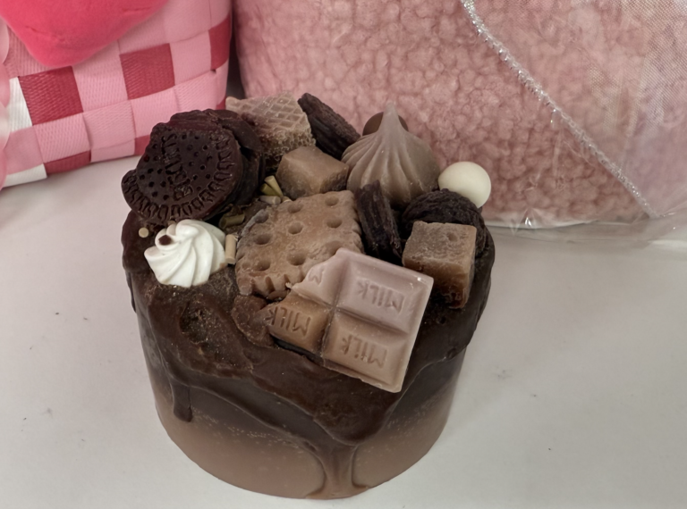 DIY birthday cake candle-making workshop with colorful materials and creative designs.