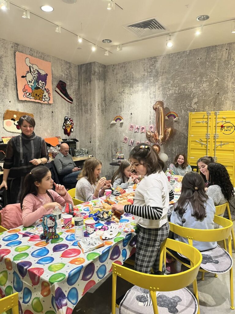 Children enjoying a fun and creative birthday party at Crafts Zone, engaging in arts and crafts activities with snacks and decorations.