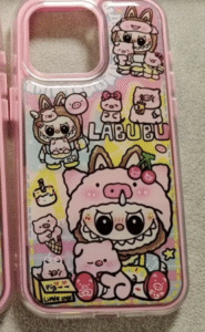 A colorful pink phone case featuring cartoon-style illustrations of the character Labubu dressed in a pig costume, surrounded by multiple playful pig designs, hearts, stars, and food-themed doodles like cake and ice cream. The case has a cheerful, childlike aesthetic with bold outlines and pastel backgrounds.
