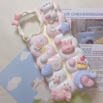 A decoden phone case decorated with faux cream and colorful embellishments, featuring intricate details and playful designs.