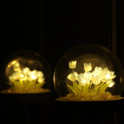 A handcrafted tulip lamp featuring vibrant colors and elegant floral designs, created at Crafts Zone.