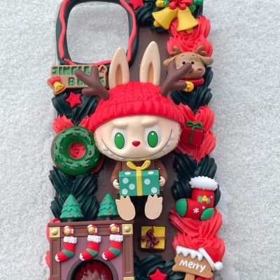A Christmas-themed Decoden Cream iPhone case featuring festive designs with colorful decorations and holiday charm.