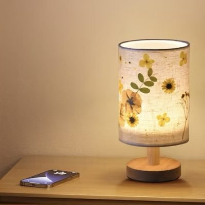 A handcrafted decoupage lamp with intricate floral patterns and a warm, soft glow.