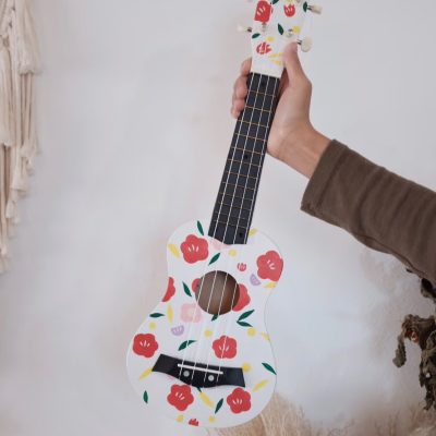 A painted ukulele featuring vibrant, hand-drawn designs with colorful patterns and artistic details.