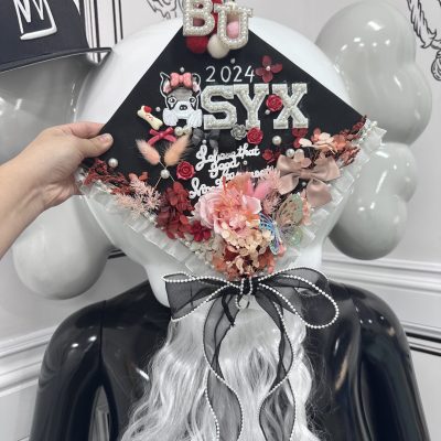 A creatively designed graduation hat featuring vibrant decorations and personalized artwork, crafted at Crafts Zone.
