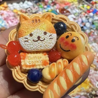 Miniature bread basket with cat-shaped cookie and smiling bun